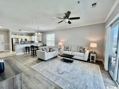 Living room with ceiling fan with notable chandeli