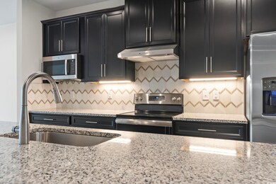 Kitchen featuring granite counters, stainless stee