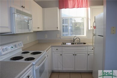 Bright cheery kitchen has plenty of cabinets and c