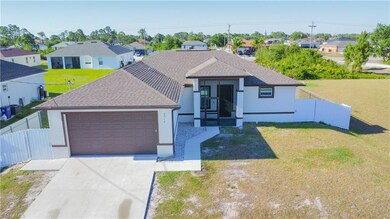 Ranch-style house featuring fence, a garage, stucc