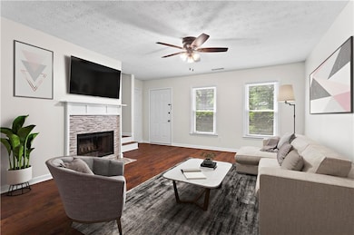 Living room with wood finished floors, a ceiling f