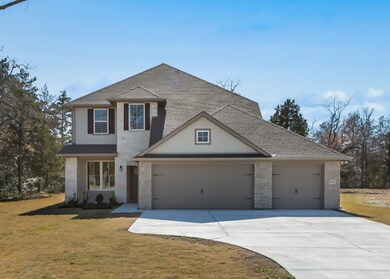 View of front facade featuring a garage and a fron