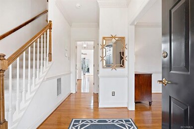 Hardwood foyer with dentil crown molding.