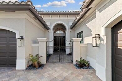 Doorway to property with a gate, a tile roof, and stucco siding