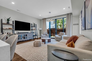 Living area featuring wood finished floors and recessed lighting
