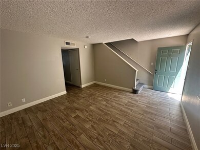 Unfurnished living room featuring wood finished fl