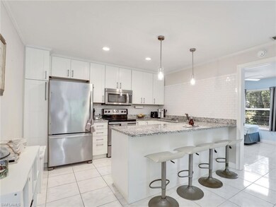 Kitchen featuring kitchen peninsula, tasteful back