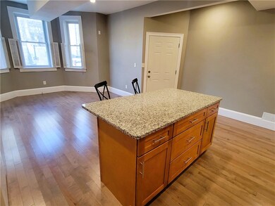 Reverse view of generous living room, showing entr