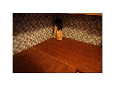 . Butcher block counters and back splash tile.