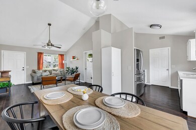 View of the living room, kitchen and dining room from the rear of the home. Pantry cabinet for extra storage.