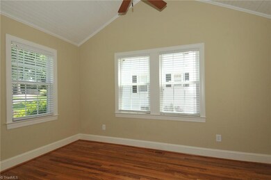 Sunroom with vaulted beadboard ceiling off living room