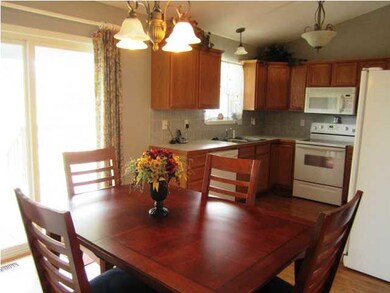 Kitchen/dining offers wood laminate flooring, grea