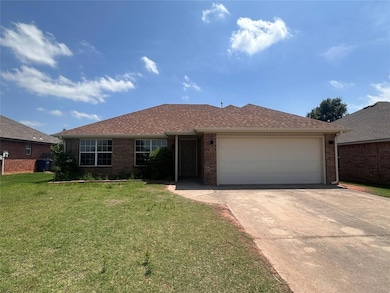 Single story home with concrete driveway, a garage, a front yard, brick siding, and roof with shingles