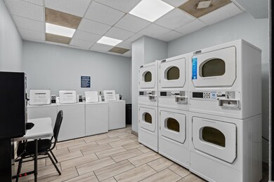 Laundry room featuring stacked washing maching and