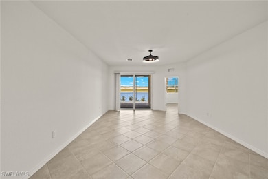 Unfurnished room with light tile patterned floors