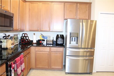 Kitchen with brown cabinets, light tile patterned