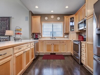 Large kitchen with breakfast bar is open to the gr