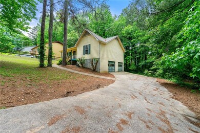 View of side of home with driveway and a garage