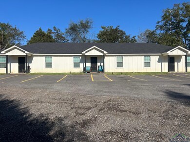 View of property featuring uncovered parking