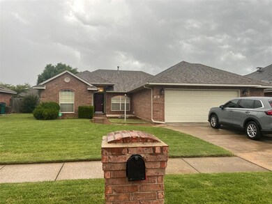 Ranch-style home with roof with shingles, brick siding, concrete driveway, an attached garage, and a front yard