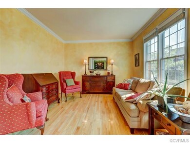 Living room with hardwood floors, crown molding, d