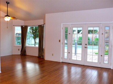 Living room laminate floors, French doors, sloped 