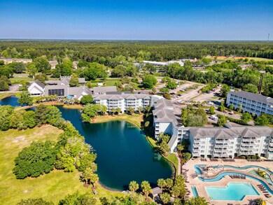 Birds eye view of property with a water view and a