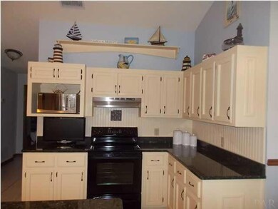 Smooth top range and more wood cabinets.