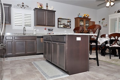 Kitchen with stainless steel dishwasher, ceiling f