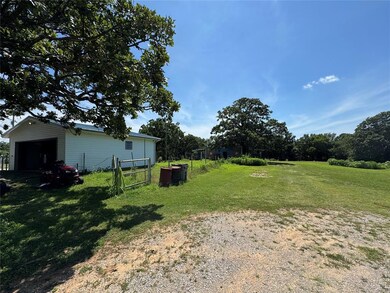 View of yard with an outdoor structure and a detached garage