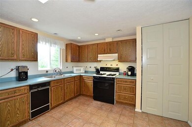 Large eat in kitchen with ceramic tile floor, skyl