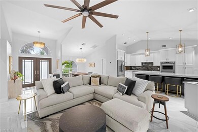 Living room with ceiling fan with notable chandeli