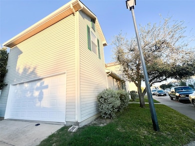 View of side of property with a garage
