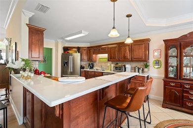 Kitchen with light countertops, visible vents, sta