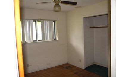 Unfurnished bedroom featuring a ceiling fan, baseb