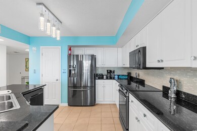 Kitchen featuring hanging light fixtures, applianc