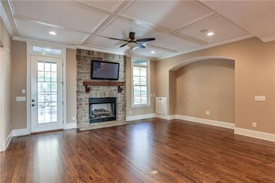 Great Room with Coffer Ceiling detail, stacked stone gas log fireplace.