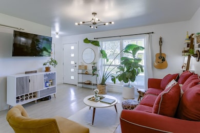 Living area featuring a chandelier and light wood
