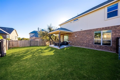 Fenced backyard with an outdoor living space and a patio