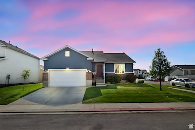Ranch-style house featuring concrete driveway, a front lawn, stucco siding, brick siding, and a garage