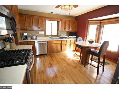The bright and sunny Kitchen offers hardwood floor