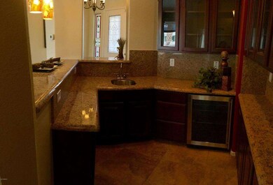 bar with wine fridge, sink and cabinets