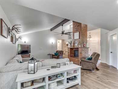 Living room featuring a fireplace, lofted ceiling 