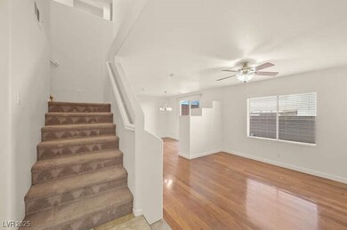 Stairs wood finished floors, and ceiling fan