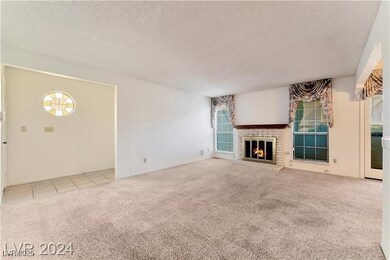 Unfurnished living room featuring a textured ceili