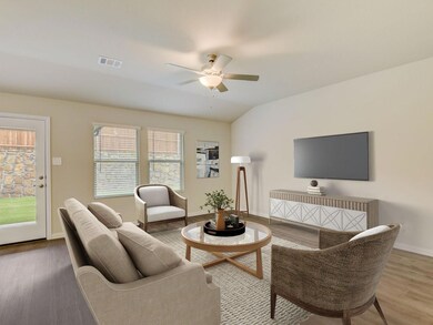 Living room with ceiling fan, wood-type flooring, and vaulted ceiling