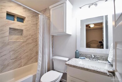 Full bath featuring vanity, shower / tub combo with curtain, and ceiling fan