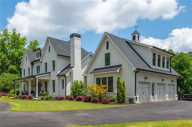 Timeless luxury farmhouse style home greets you with welcoming curb appeal and circular driveway