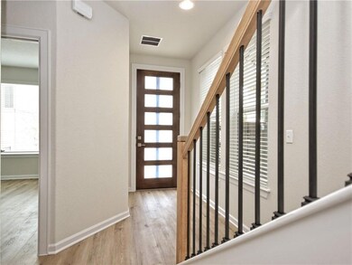 Entryway featuring stairs, wood finished floors, 