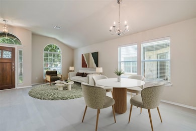 Dining area with a chandelier, vaulted ceiling, l